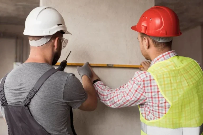 Construction workers working on a wall