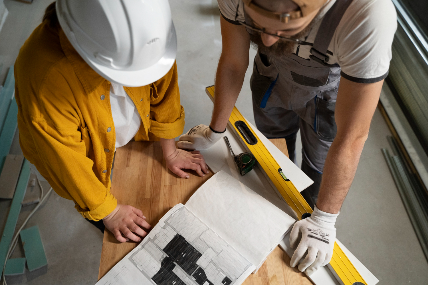 Two workers planning construction